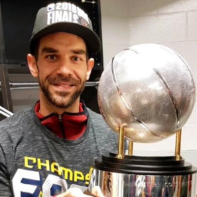 Jose Manuel Calderón holding a silver basketball championship trophy